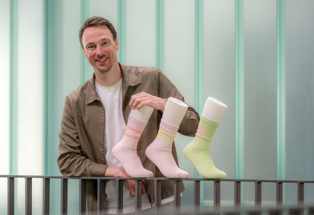 Roman Hurka mit drei Socken-Modellen des Start-ups ooley. 